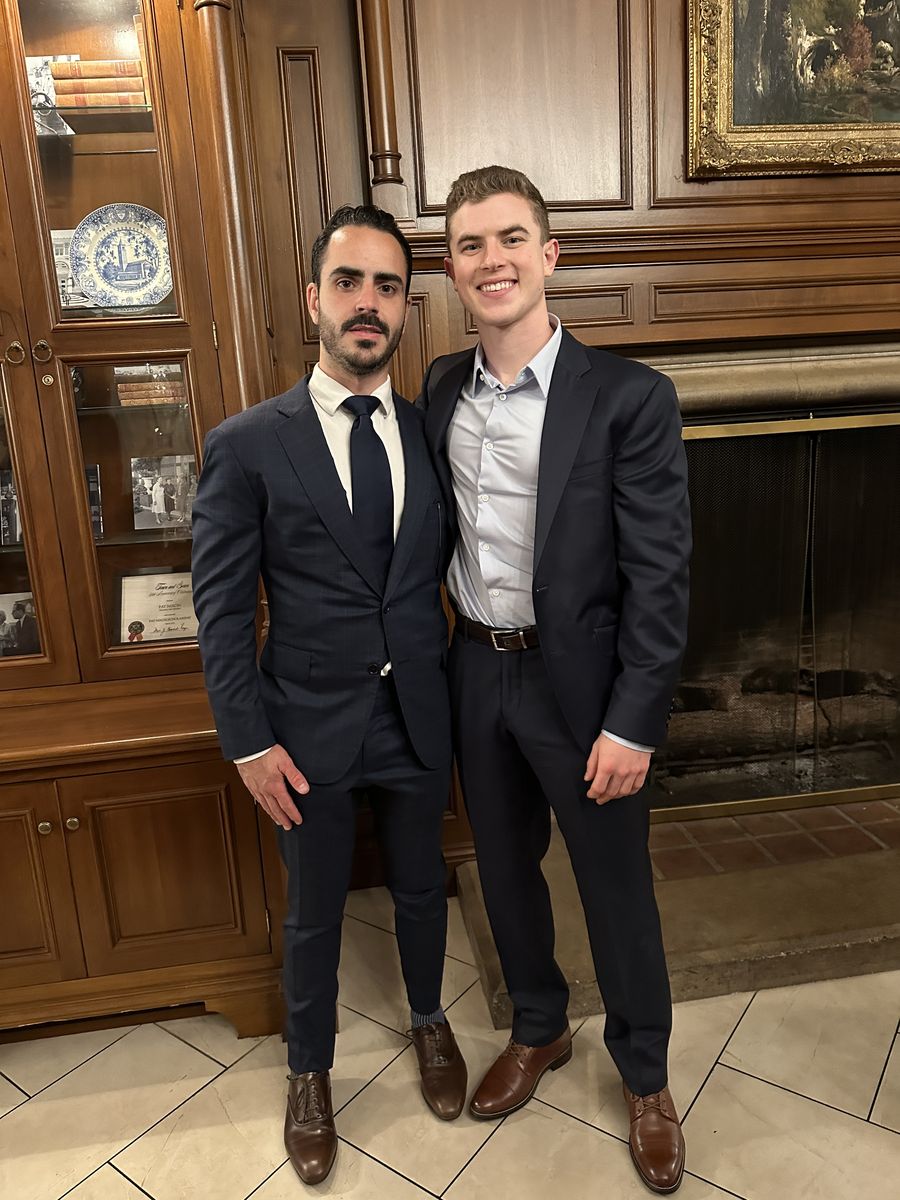 Two founders standing together at a fireside event