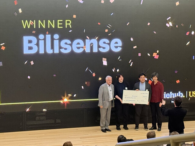 A founder team receiving an award on stage