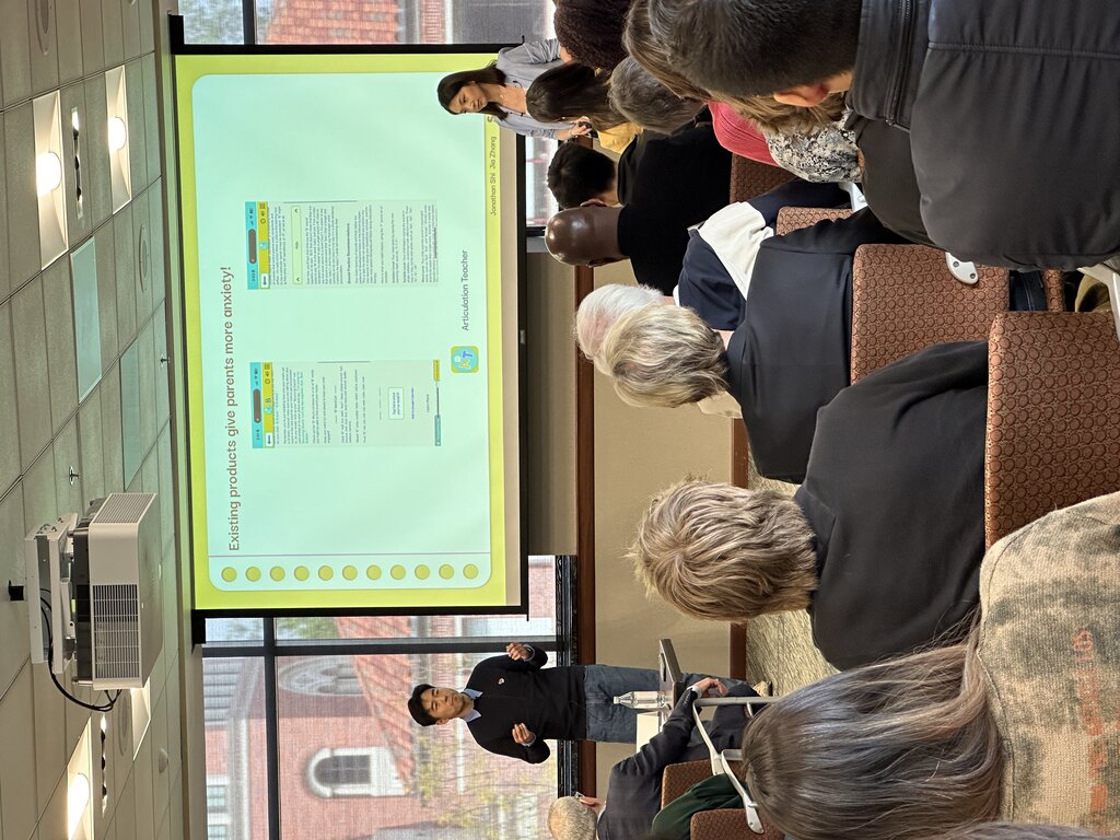 Founders presenting to mentors and an audience