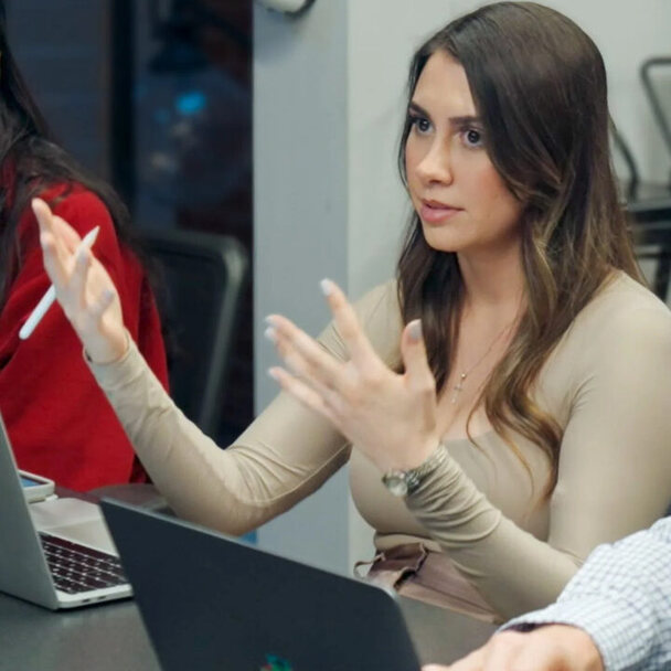 A founder talking through her plans with a mentor over open laptops